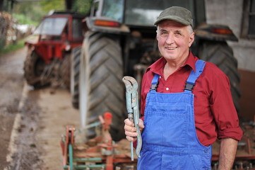 Farmer repairing his red tractor, model is real farmer