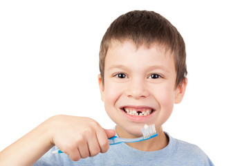 Boy portrait with lost tooth on toothbrush