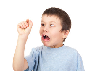 grimacing boy looks at lost tooth