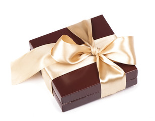 Box with candies and golden tape isolated on the white