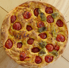 Apulian focaccia with tomatoes and peppers cooked in the oven