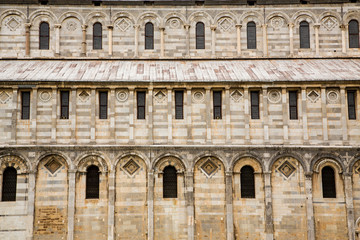 Fototapeta na wymiar Wall and Windows on Ancient Pisa Church
