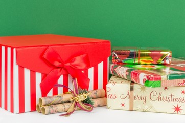 A Christmas gift box and presents with green background