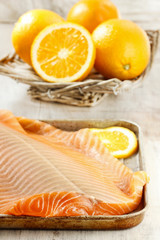 Big raw salmon fillet on wooden table