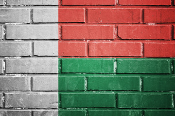 Madagascar flag on a textured brick wall