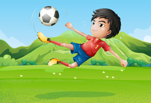 A young boy playing football at the field