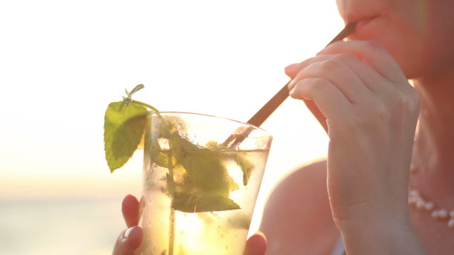 Woman enjoying a mojito cocktail