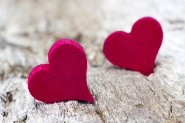 Fototapeta premium two red hearts on wooden background