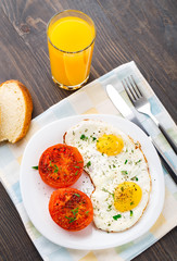 Breakfast with fried eggs and tomato