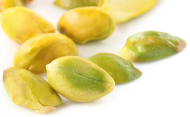 Green Pistachios over white background
