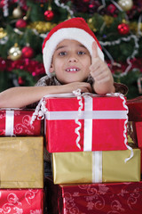 Obraz na płótnie Canvas Happy little boy smiling with gift box near the Christmas tree