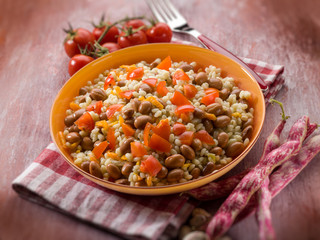 barley risotto with beans and tomatoes, selective focus