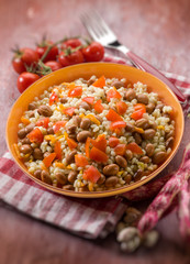barley risotto with beans and tomatoes, selective focus
