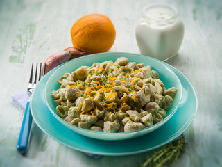 pasta with artichoke cream and orange peel, selective focus