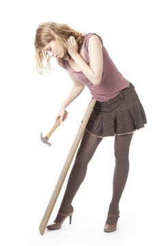 Young Pretty Woman With Hammer And Wood