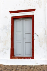 Obraz na płótnie Canvas A weathered blue door on the island of Santorini, Greece, Europe