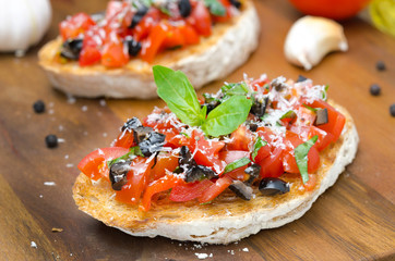 bruschetta with tomato, olives, basil, cheese, horizontal