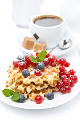 delicious breakfast with Belgian waffles, berries and coffee
