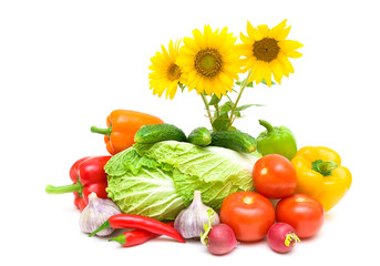 bouquet of blooming sunflowers and fresh vegetables on a white b