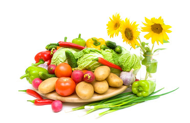 fresh vegetables and sunflowers on a white background