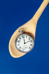 pocket watch on a wooden spoon