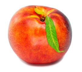 Ripe nectarine with a green leaf on a white background..