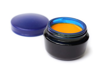 Homemade cream with sea buckthorn oil in blue glass can