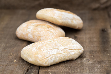 Panini rolls in rustic kitchen setting with cooking utensils