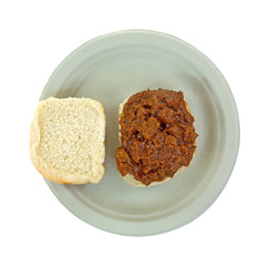 Chipped pork in barbecue sauce sandwich on a paper plate