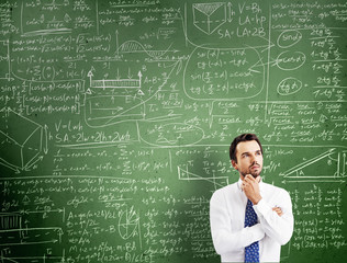 thinking man against desk with formulas