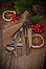 Vintage silverware on rustic wooden background with christmas de