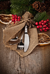 Vintage silverware on rustic wooden background with christmas de