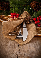 Vintage silverware on rustic wooden background with christmas de