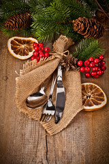 Vintage silverware on rustic wooden background with christmas de