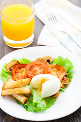 Light breakfast with soft egg, tomato and croutons