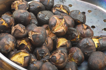 Delicious roasted chestnuts group in a pot