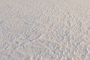 Light and shade on snow. A natural background, a structure.