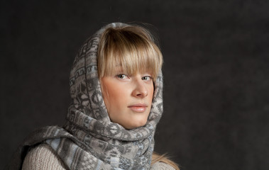 winter fashion shot of a beautiful girl with long curled blonde