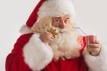 Portrait of Santa Claus Drinking milk from glass
