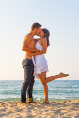 Young couple love play at the beach