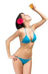 Fototapeta premium Portrait of woman wearing bikini who keeps cut of orange 