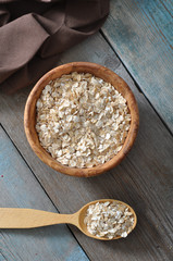 Oat flakes in wooden bowl