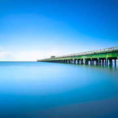 Industrial pier on the sea. Side view. Long exposure photo