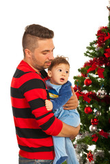 Father and son near Christmas tree