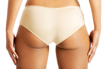 Fit woman's buttocks in panties.