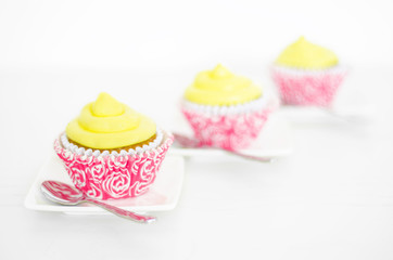 Three cupcakes on white background, selective focus