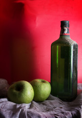 Antique wine or whiskey bottle with apples