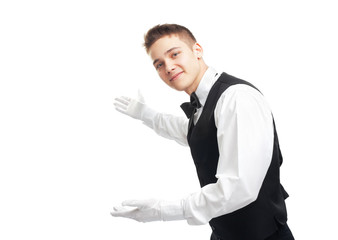 young happy smiling waiter gesturing welcome