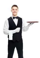 Young smiling waiter with empty tray