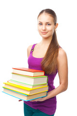 Smiling student girl holding stack of books